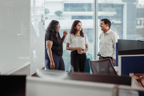 A group of smiling colleagues stood together in the office